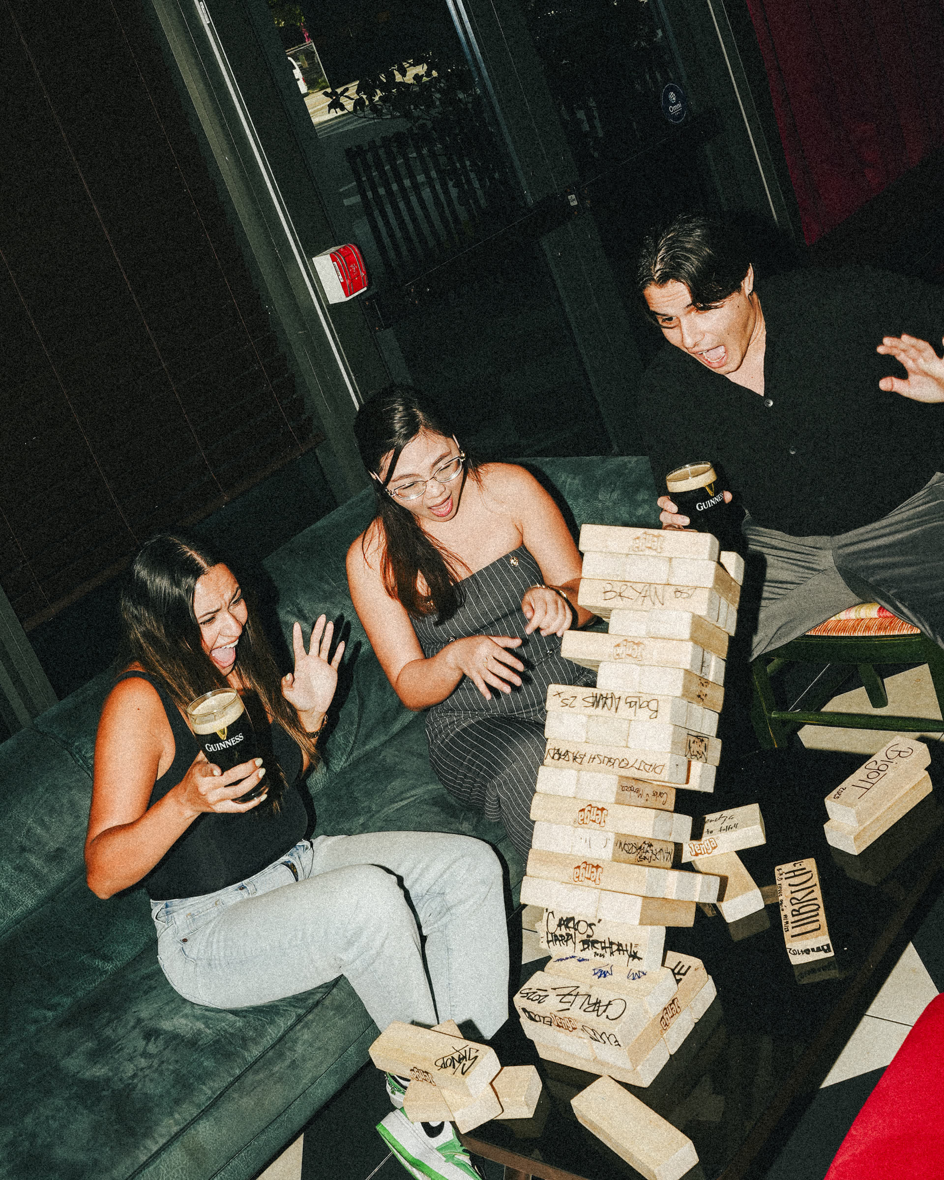 Friends playing Jenga with Guinness at The Leinster pub night Miami